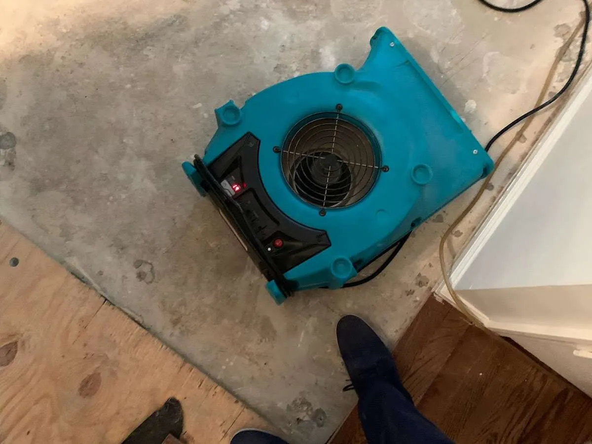 Air mover drying subfloor during Leak Detection & Repair in North Castle